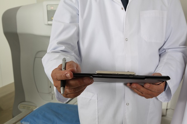 Medico in camice bianco compila un modulo su un tablet